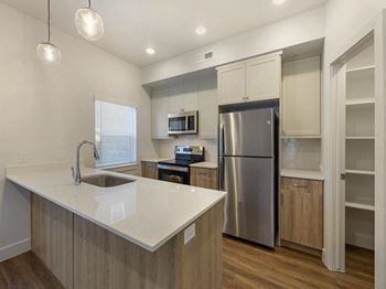 a kitchen with a large island and stainless steel appliances at Desert Sage Townhomes, Hurricane, UT